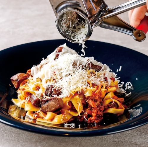 Bolognese with a mountain of cheese and chunks of beef tongue