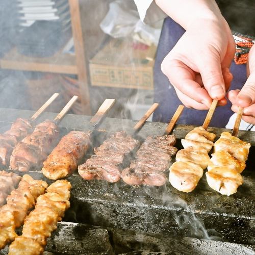 Brand skewers grilled over charcoal fire