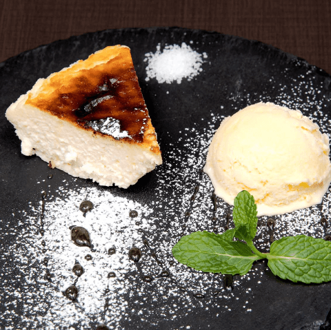 Basque-style cheesecake with vanilla ice cream