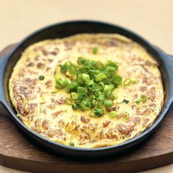 Soft-boiled eggs and chive and egg on a hot plate