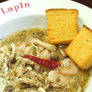 Shrimp, mushrooms and seasonal vegetables sautéed with garlic “Ajillo”