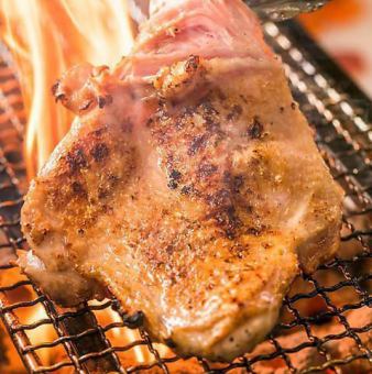 One slice of free-range chicken grilled on an iron plate