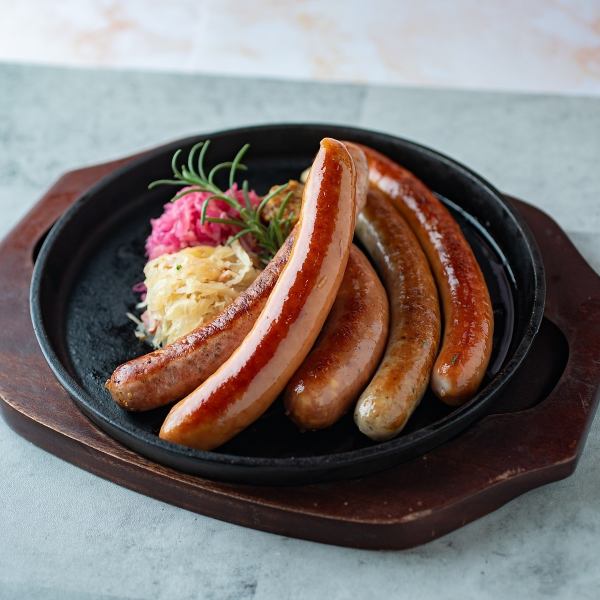 Juicy [Special German Sausage] served on a piping hot iron plate. It goes perfectly with beer!