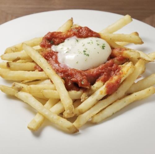 French fries with bravas sauce and warm egg