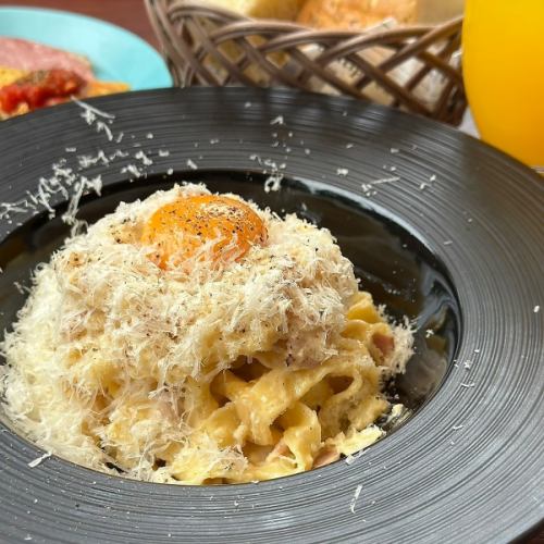 Carbonara cooked in front of you on a large piece of Parmesan (includes appetizer salad, all-you-can-eat homemade focaccia, and soup)