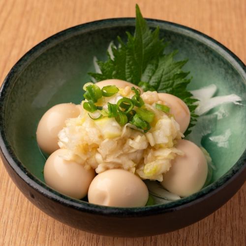 Quail eggs topped with green onions, salt and lemon