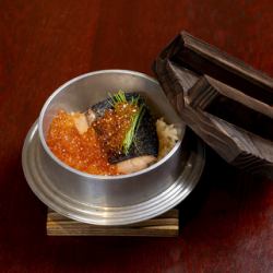 Salmon and salmon roe rice cooked in a pot