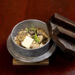 Oyster rice cooked in a pot with soy sauce and butter