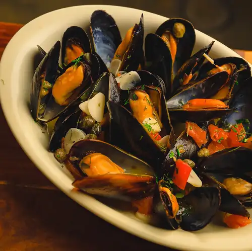 A huge pile of steamed mussels in sake