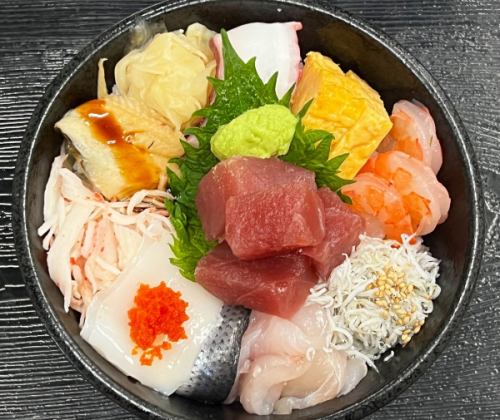 Bowl of rice topped with sashimi