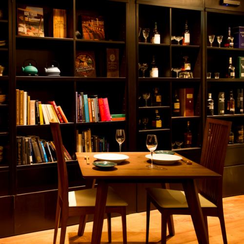 Table seats overlooking the back bar and bookshelves