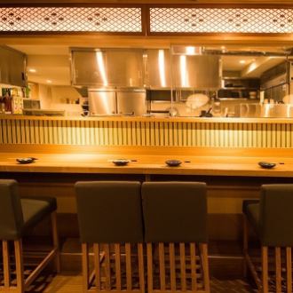 Counter seats in front of the lively open kitchen.