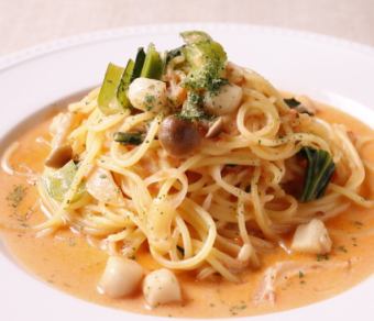 Dinner set of pasta with shrimp and seasonal vegetables in tomato cream sauce