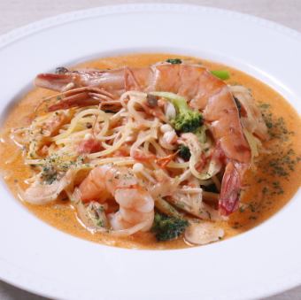 Fresh pasta with large shrimp and spring vegetables in a tomato cream sauce.