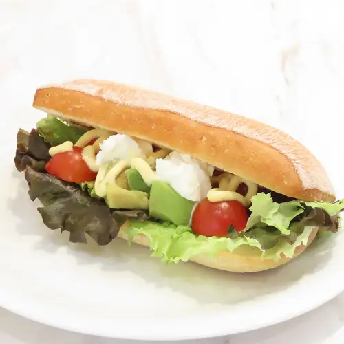 A luxurious sandwich overflowing with ingredients