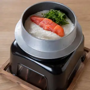 Rice cooked in dashi broth, mentaiko and grated yam rice cooked in a pot