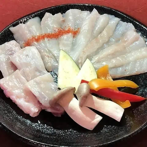 A luxurious grilled pufferfish with concentrated umami flavor