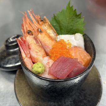 Bowl of rice topped with sashimi