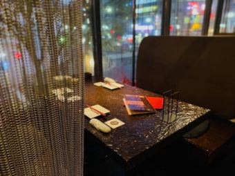Sofa seats by the window overlooking the night view of Susukino