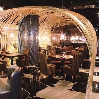 Table seats surrounded by a fantastic bamboo arch