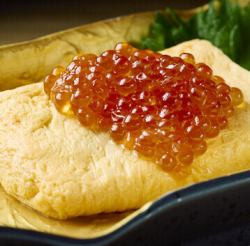 Rolled omelet topped with salmon roe