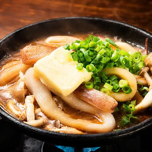Squid with butter on a hot plate