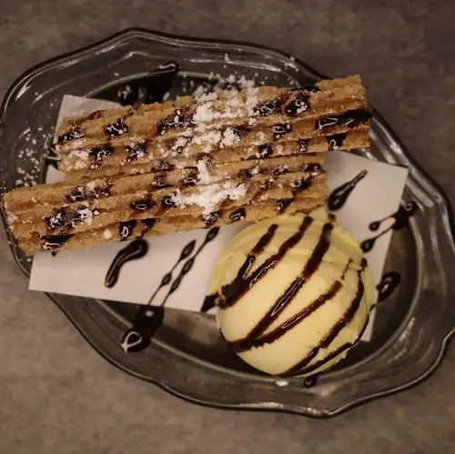 Freshly fried churros and vanilla ice cream