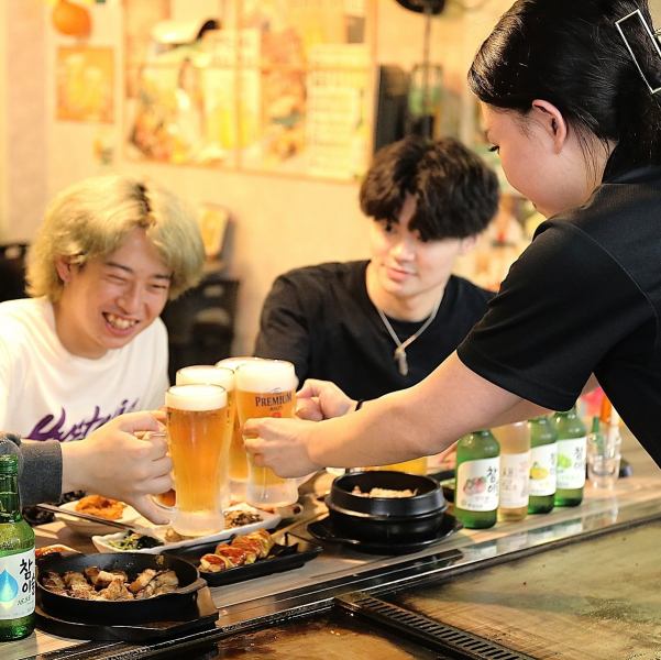 【ワイワイ活気ある店内♪】当店では、楽しい雰囲気の中で韓国料理と、チャミスルやマッコリなどの韓国酒を味わいながら、賑やかに過ごせる空間！オープンキッチンの鉄板焼きを取り囲むカウンター席では、シェフとの距離が近く、料理を待ちながらコミュニケーションを楽しむことができるよ！
