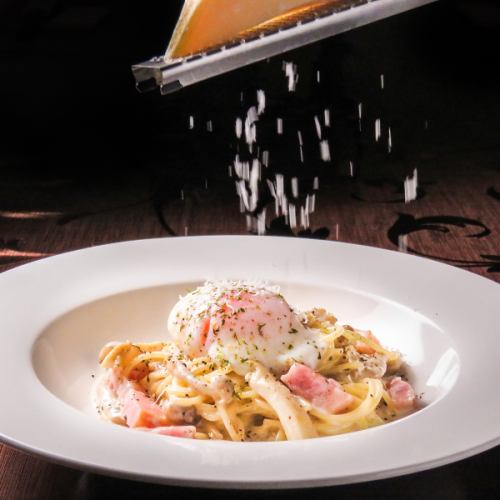 Thick-sliced bacon, soft-boiled egg and grated cheese carbonara