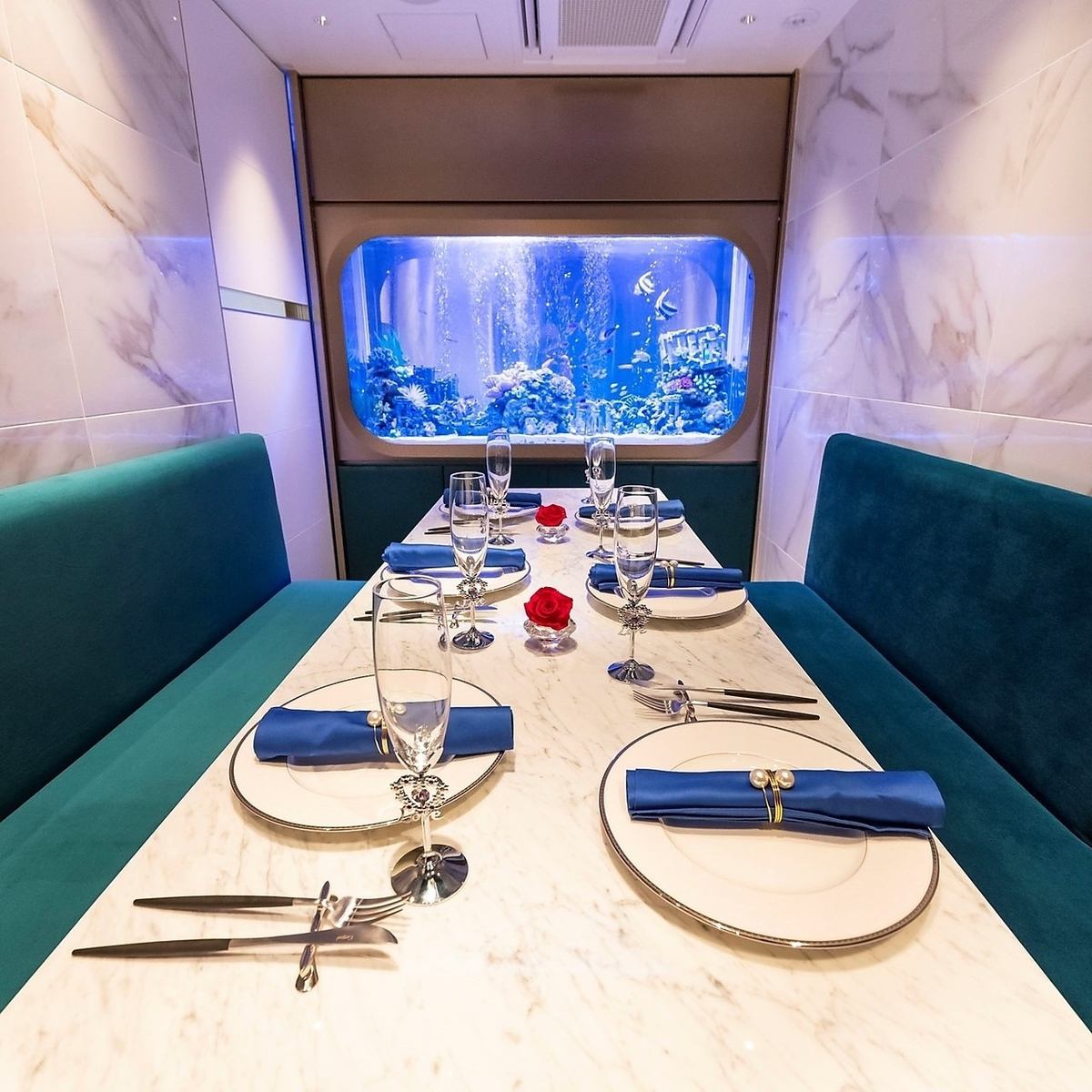 A complete private room that is healed by a large cobalt blue aquarium that feels like you are in the sea