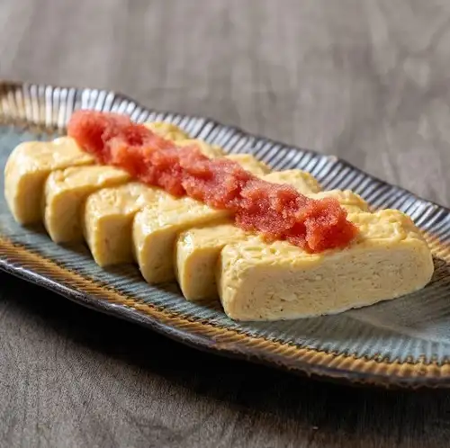 Rolled omelet topped with mentaiko (spicy cod roe).