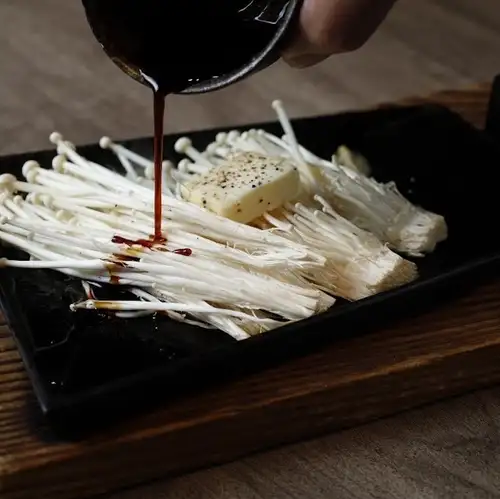 Grilled raw enoki mushrooms with Kyushu-style soy sauce and butter