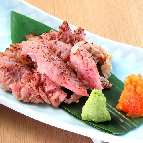 Thick-cut bacon grilled over straw