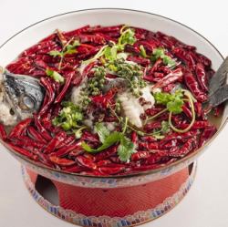 Super spicy grilled fish on an iron plate
