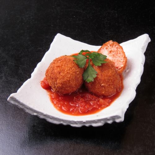 Homemade arancini (rice balls) with tomato and grated cheese