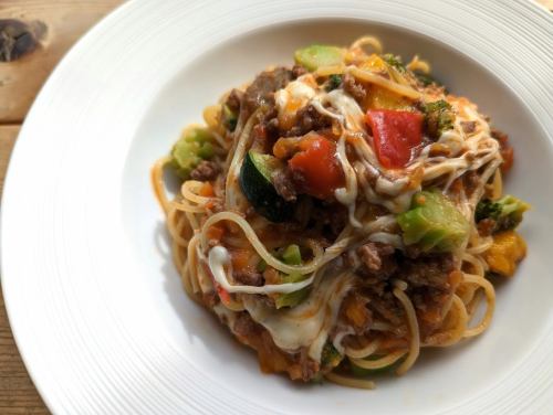 Bolognese pasta or risotto with colorful vegetables and mozzarella cheese