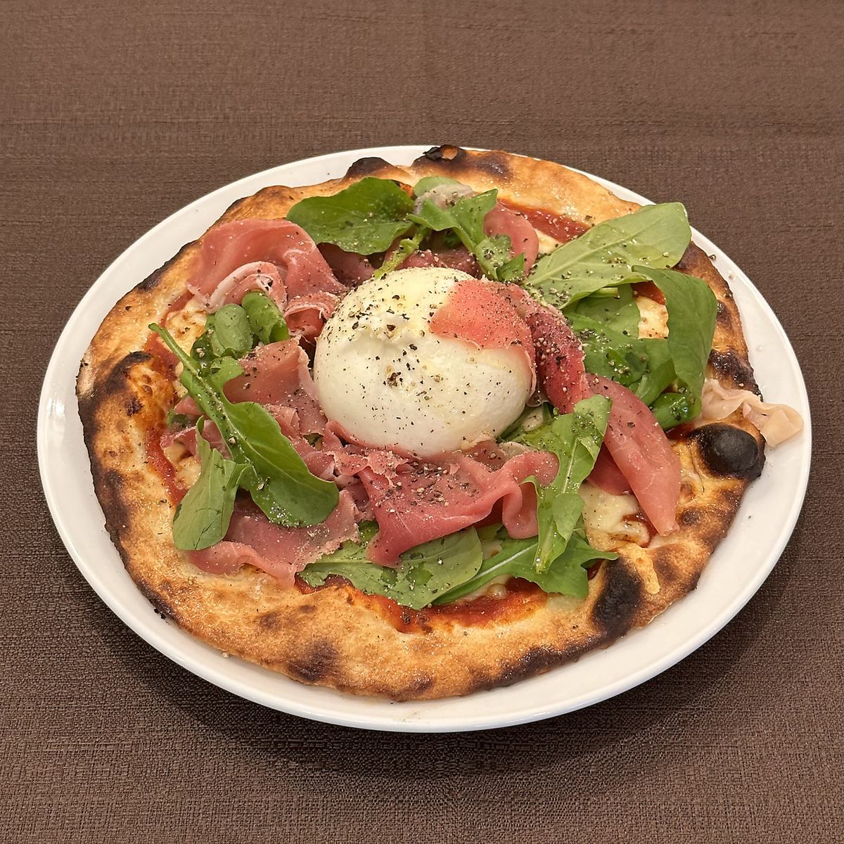 Our recommended dish is "Burrata and prosciutto pizza"
