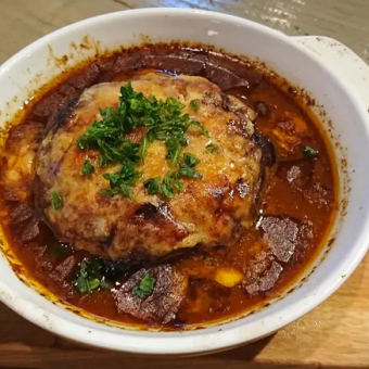 Braised hamburger steak with raclette cheese and demi-glace sauce