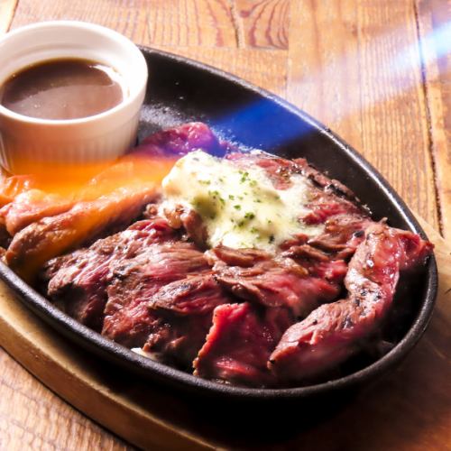 200g beef skirt steak on a hot plate - topped with herb butter -