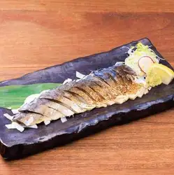A rare, freshly seared piece of fatty mackerel.