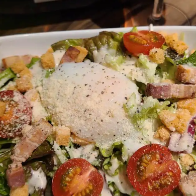 Caesar salad with soft-boiled egg and grilled bacon