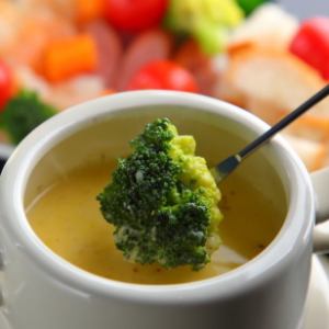 Original cheese fondue with vegetables and sausages