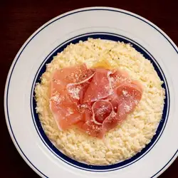 Cheese risotto with a generous serving of prosciutto