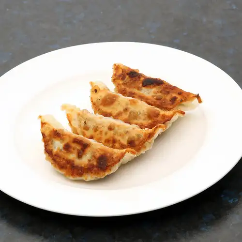 4 pieces of grilled dumplings with bok choy