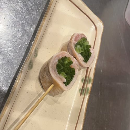 Small green onion wrapped in pork