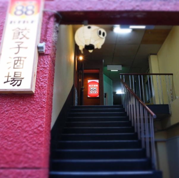 The red signboard, goodwill, and Buta-san's lanterns are the landmarks of the entrance.