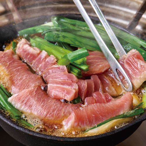 Raw tuna sukiyaki style (made with raw tuna belly) with raw egg