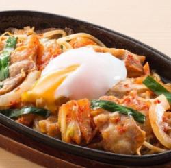 Stir-fried pork and egg with kimchi on a hot plate