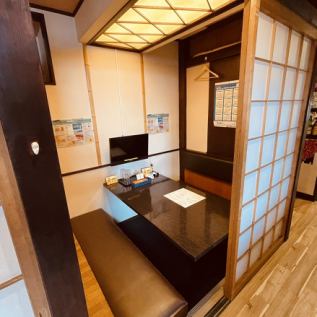 It is a private room with a sunken kotatsu table with a TV.