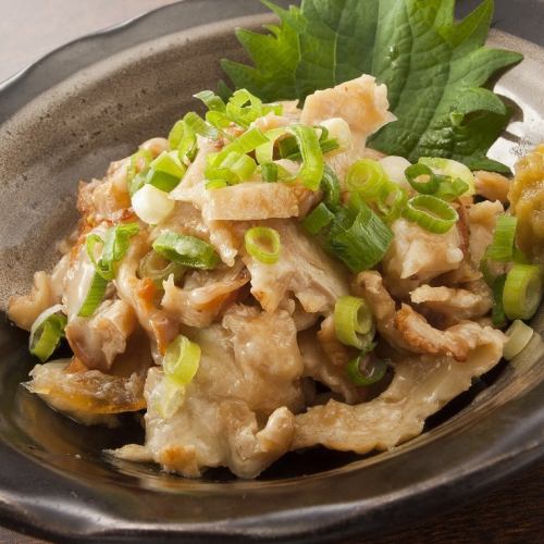Chicken skin covered in green onions with ponzu sauce